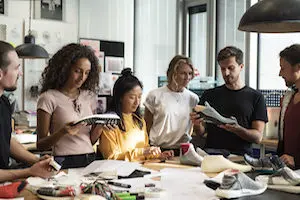 Photograph of people collaborating around a table
