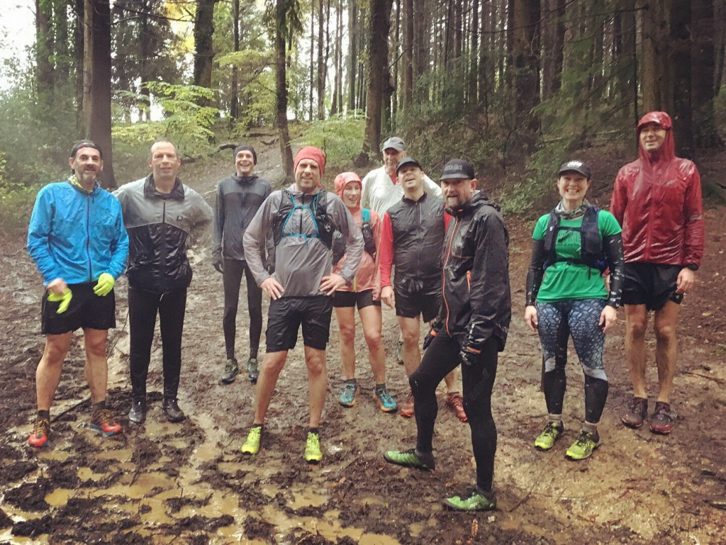 A group of trail runners in a wooded area