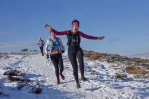 A woman jumping in the snow
