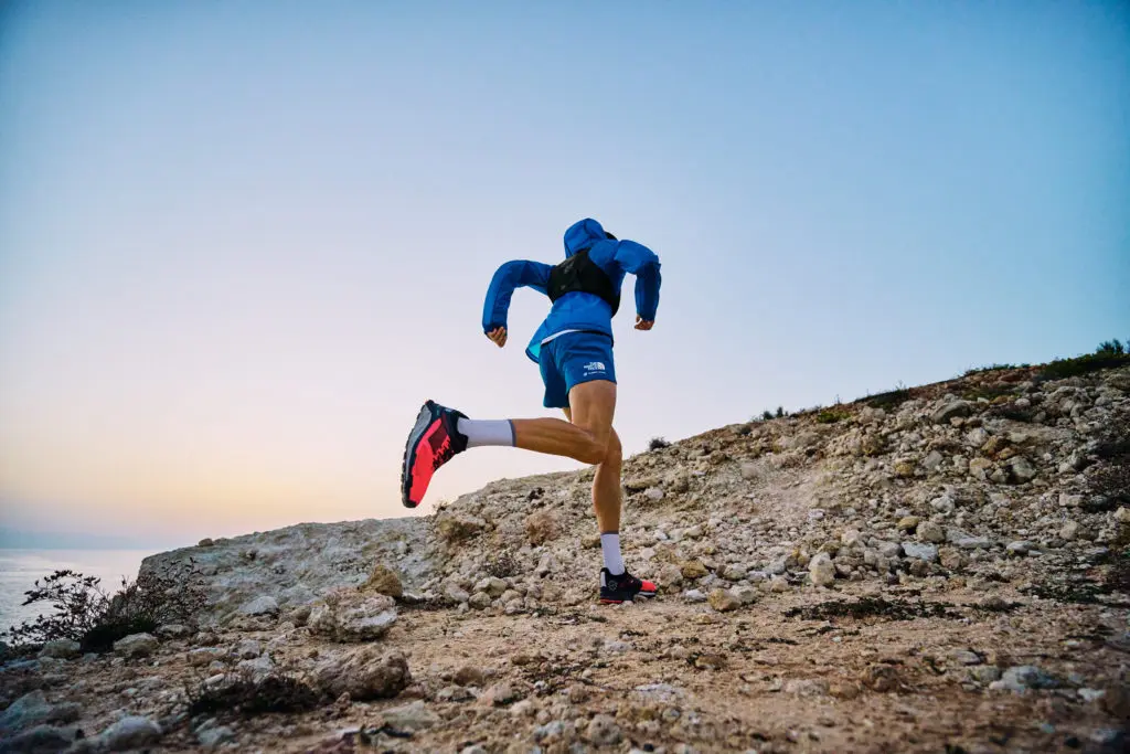 A photograph of a man running up a mountain