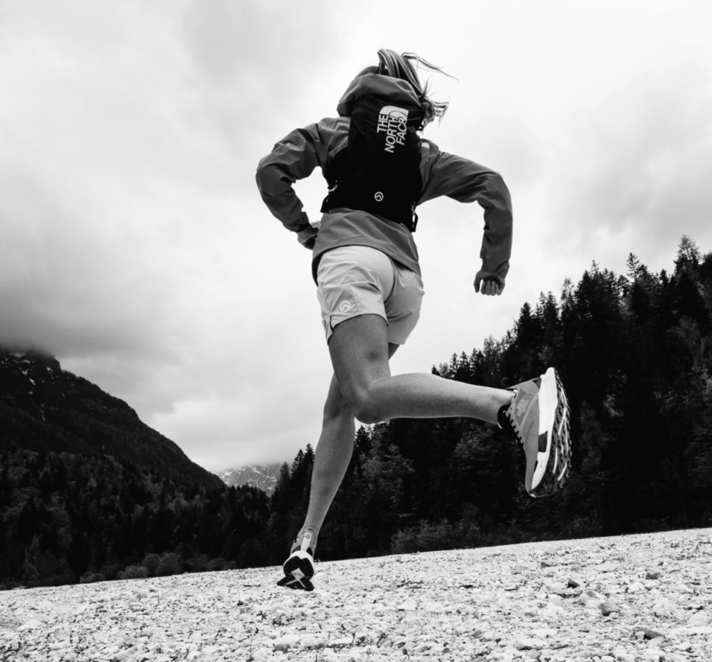 A black and white photo of a woman running
