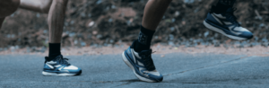 A photograph of some runners' feet with a quote overlaid