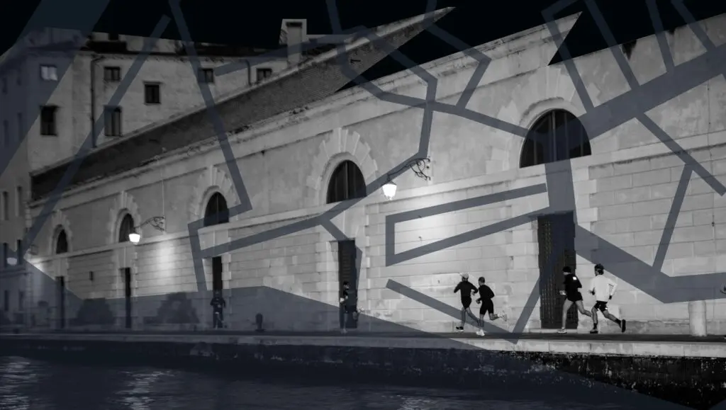 A black and white photo of people running along the canal