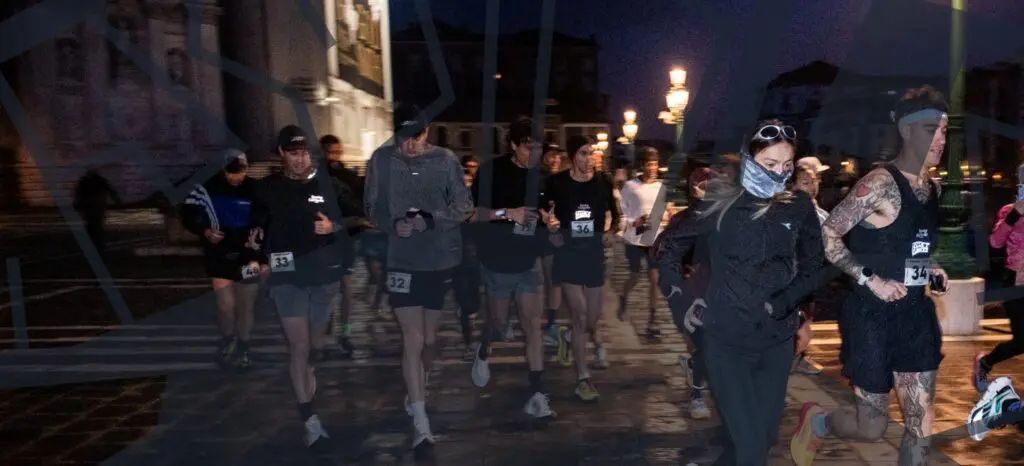 A photo of a group running through Venice