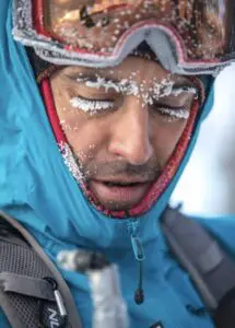 A close up photo of a man with frozen eyebrows and eye lashes 