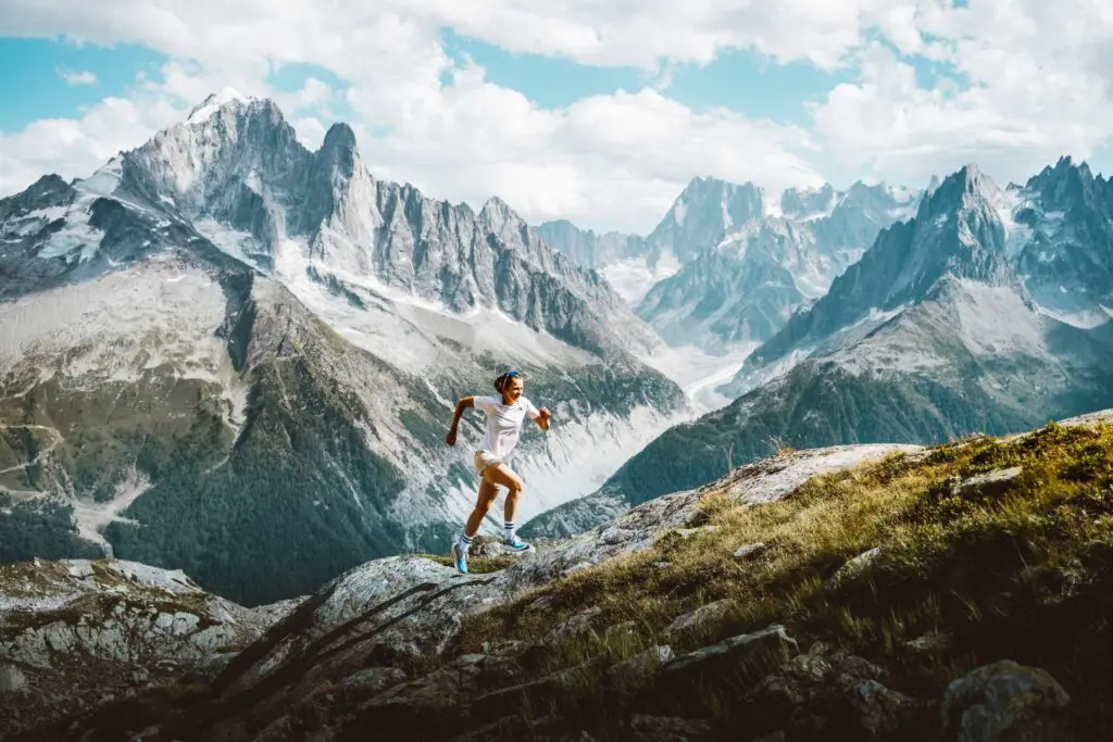 A photograph of a woman running through a mountain