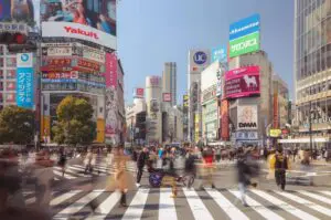 A photo of Shaun and Shamus at a road crossing in Tokyo surrounded by the hustle and bustle
