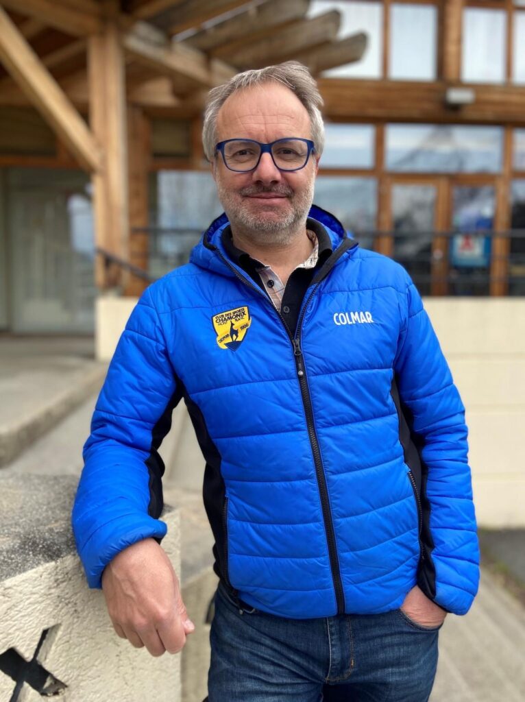 A photo of a man in a blue puffer jacket